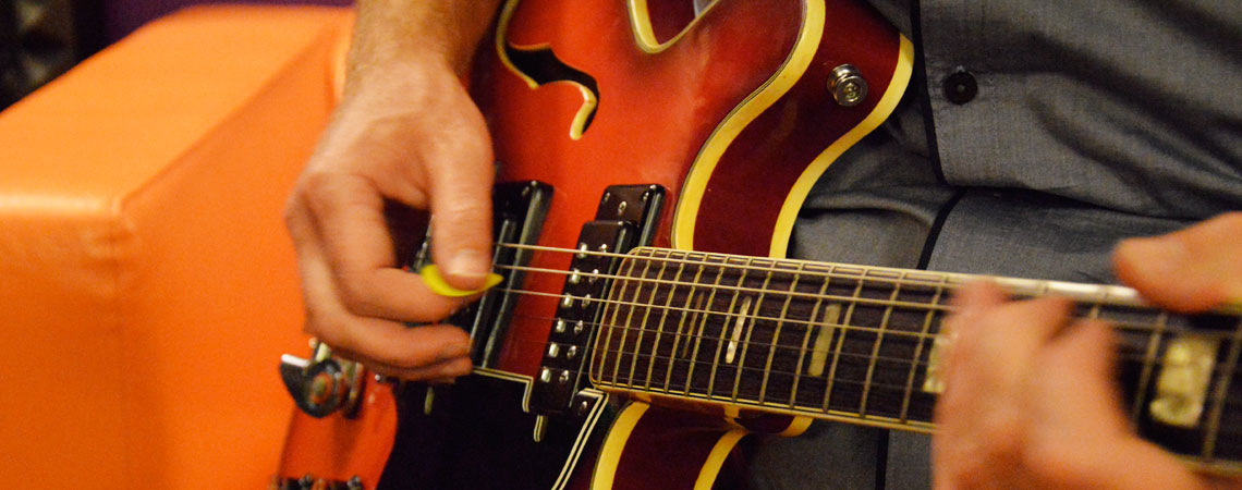 Playing an Epiphone guitar