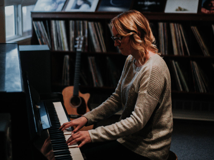 Young female songwriter at piano